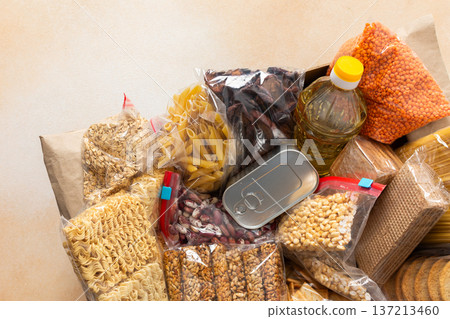 Canned goods, cereals, and pasta stored for quarantine and isolation, ensuring long-term survival and food security at home, survival during military operations, the concept of stay at home 137213460