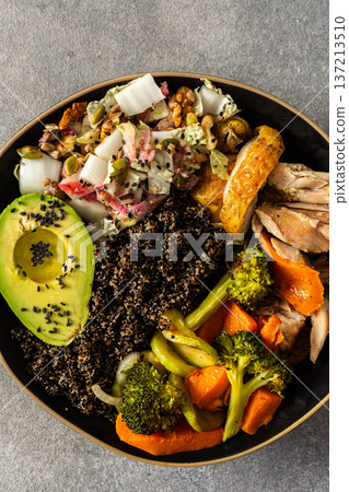 Nutritious, wholesome breakfast featuring quinoa, avocado, roast chicken, and roasted vegetables like sweet potato, zucchini, and broccoli, complemented with a fresh cabbage and radish salad Nutritious, wholesome breakfast featuring quinoa, avocado, roast chicken, and roasted vegetables like sweet potato, zucchini, and broccoli, complemented with a fresh cabbage and radish salad 137213510