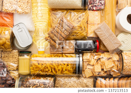 Canned goods, cereals, and pasta stored for quarantine and isolation, ensuring long-term survival and food security at home, survival during military operations, the concept of stay at home 137213513