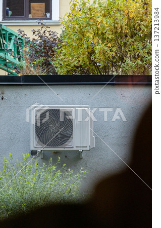 air conditioning on facade of building, air cooling in hot weather.  137213984