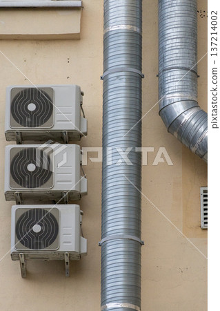 air conditioning on facade of building, air cooling in hot weather. air conditioning on facade of building, air cooling in hot weather. 137214002