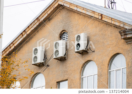 air conditioning on facade of building, air cooling in hot weather. air conditioning on facade of building, air cooling in hot weather. 137214004