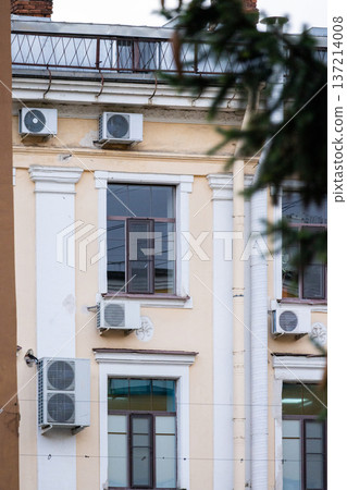 air conditioning on facade of building, air cooling in hot weather. air conditioning on facade of building, air cooling in hot weather. 137214008
