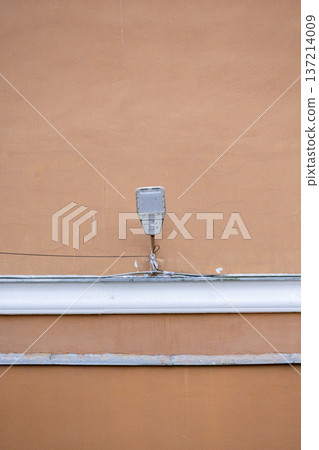 modern street lamp on the background of a beige building. modern street lamp on the background of a beige building. 137214009