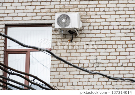 air conditioning on facade of building, air cooling in hot weather. air conditioning on facade of building, air cooling in hot weather. 137214014