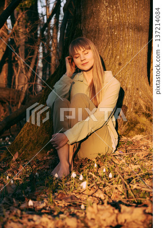 Young Woman with Eyes Closed in Spring Forest Young Woman with Eyes Closed in Spring Forest 137214084