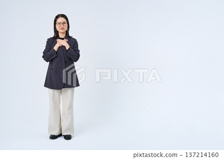 A businesswoman posing with her hand on her chest 137214160