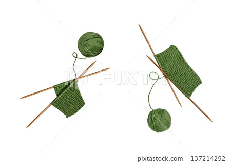Green knitted wool with knitting needles for knitting warm clothes and hobbies needlework isolated on white background. 137214292