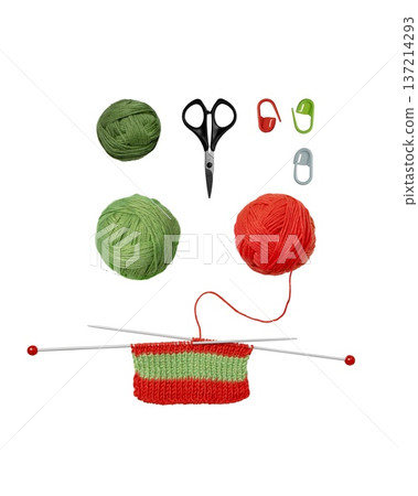 Tools for knitting warm clothes: scissors, green and red balls of thread, stoppers, and knitting needles with knitted green red piece of fabric isolated on transparent background. Hobby home crafts. Tools for knitting warm clothes: scissors, green and red balls of thread, stoppers, and knitting needles with knitted green red piece of fabric isolated on transparent background. Hobby home crafts. 137214293