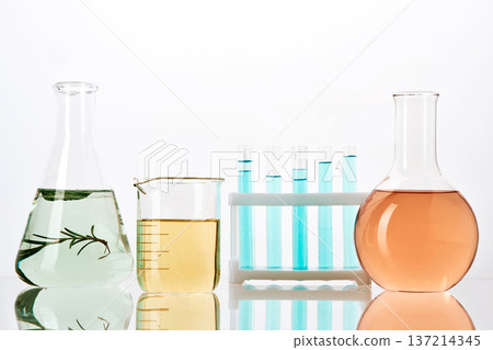 Laboratory glassware containing colorful liquids and natural extracts Laboratory glassware containing colorful liquids and natural extracts 137214345