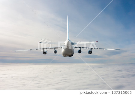 Rear view of the big transport airplane flies in the air above the clouds Rear view of the big transport airplane flies in the air above the clouds 137215065