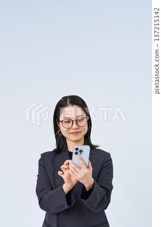 Business woman operating a smartphone 137215142