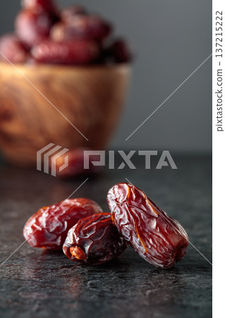 Dried dates fruit on a black table. 137215222