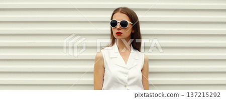 Fashion portrait of stylish young woman model, modern girl posing on white wall background 137215292