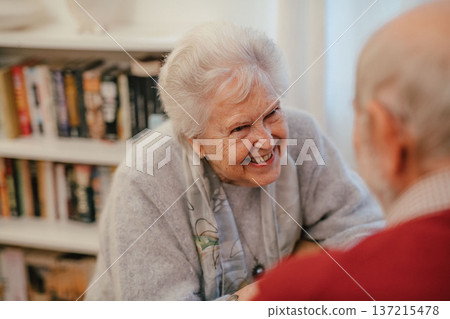 Romantic moment for senior couple at home, celebrating anniversary. Romantic moment for senior couple at home, celebrating anniversary. 137215478