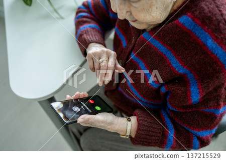 Senior facing phone scams and digital safety. 137215529