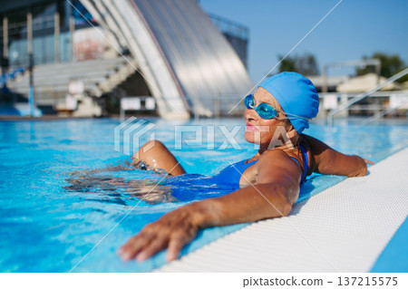 Elderly woman enjoying sport swimming for vitality and longevity. Elderly woman enjoying sport swimming for vitality and longevity. 137215575