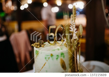 Modern birthday cake with natural decoration at birthday party. Modern birthday cake with natural decoration at birthday party. 137215609