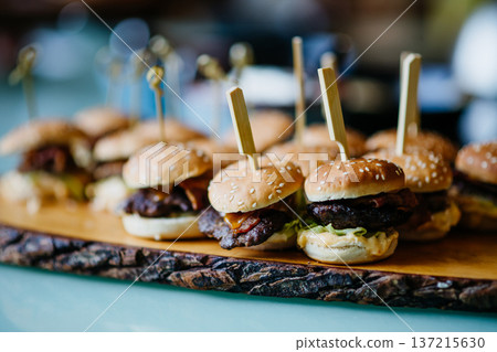 Mini burgers served on buffet table at party catering event. 137215630