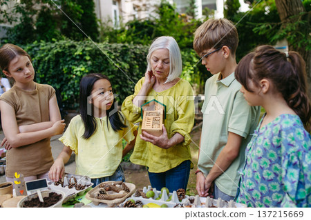 Insect hotel as educational tool for children in outdoor sustainable educational class. Insect hotel as educational tool for children in outdoor sustainable educational class. 137215669