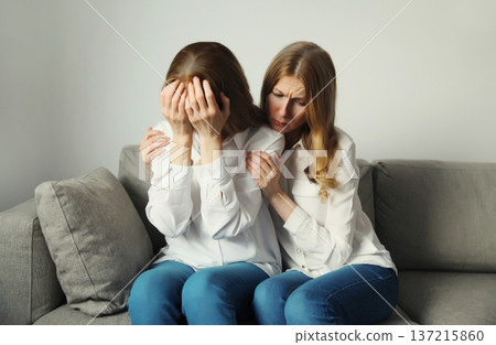 Upset offended caucasian two women, mature mother or sister and adult daughter together at home 137215860