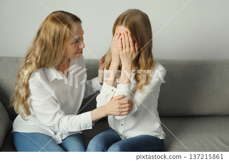 Upset offended caucasian two women, mature mother or sister and adult daughter together at home 137215861