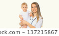 Happy smiling young woman doctor pediatrician holding little baby on white background 137215867