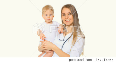 Happy smiling young woman doctor pediatrician holding little baby on white background 137215867