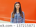 Summer portrait of happy cheerful stylish young woman posing on red background 137215871