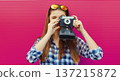 Portrait of young woman photographer with film camera, modern girl tourist taking a picture 137215872