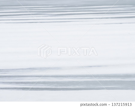Horizontal striped texture of the snow cover on the lake. 137215913