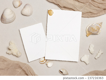 Blank paper cards mockup with seashells on beige stone, coastal wedding stationery, copy space Blank paper cards mockup with seashells on beige stone, coastal wedding stationery, copy space 137216363