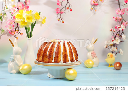 Abstract Easter composition featuring a traditional Russian meringue kulich and decorated eggs on an elegant kitchen table with spring cherry blossoms.Happy Easter concept. Screen banner Abstract Easter composition featuring a traditional Russian meringue kulich and decorated eggs on an elegant kitchen table with spring cherry blossoms.Happy Easter concept. Screen banner 137216423