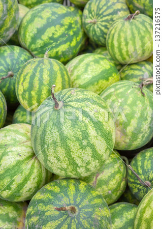 Photo of organic watermelons, selective focus. Photo of organic watermelons, selective focus. 137216575