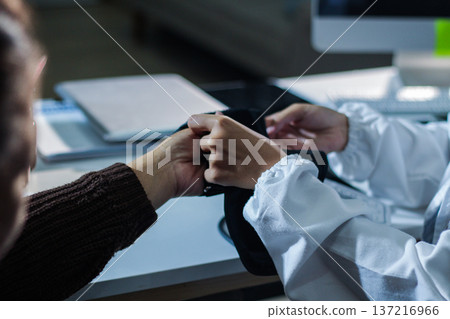 A doctor's hands carefully taking a patient's blood pressure using a sphygmomanometer. A doctor's hands carefully taking a patient's blood pressure using a sphygmomanometer. 137216966