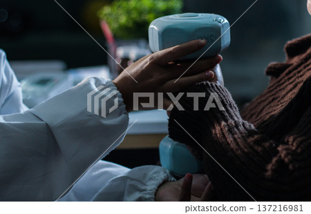 doctor is checking for muscle injuries and using dumbbells test injury and also help with physical therapy strengthen muscles because physical therapy will help strengthen muscles and help blood flow 137216981