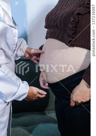 cropped shot of doctor examining pregnant woman during medical consultation cropped shot of doctor examining pregnant woman during medical consultation 137216987