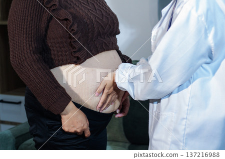 cropped shot of doctor examining pregnant woman during medical consultation 137216988