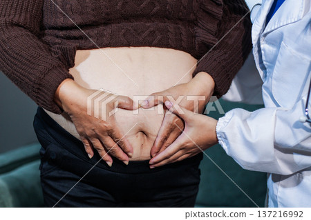 cropped shot of doctor examining pregnant woman during medical consultation cropped shot of doctor examining pregnant woman during medical consultation 137216992