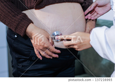cropped shot of doctor examining pregnant woman during medical consultation 137216993