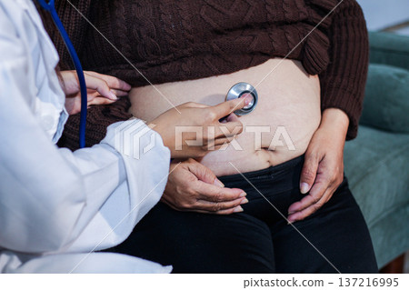 cropped shot of doctor examining pregnant woman during medical consultation 137216995