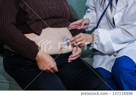 cropped shot of doctor examining pregnant woman during medical consultation 137216996