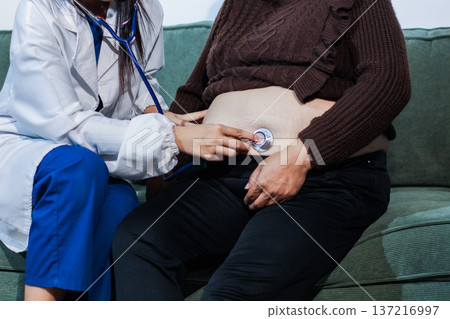 cropped shot of doctor examining pregnant woman during medical consultation cropped shot of doctor examining pregnant woman during medical consultation 137216997