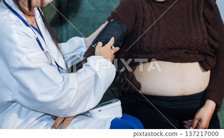 cropped shot of doctor examining pregnant woman during medical consultation 137217000
