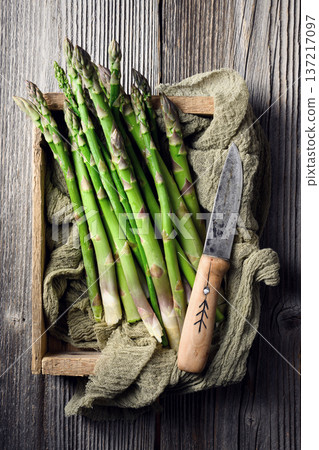 Bundled green asparagus tied with twine on kitchen cloth 137217097