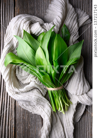 Wild garlic leaves placed on textured fabric Wild garlic leaves placed on textured fabric 137217143