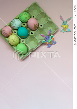 Easter eggs and small easter bunnies with pink background Easter eggs and small easter bunnies with pink background 137217289