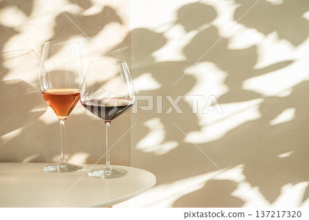 Rose and Red Wine Glasses under Sunlight. Elegant Spring Still Life Rose and Red Wine Glasses under Sunlight. Elegant Spring Still Life 137217320