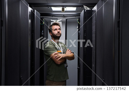 IT technician inspecting servers in a data center server room with racks and network equipment IT technician inspecting servers in a data center server room with racks and network equipment 137217542