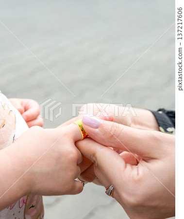Child wound treatment. Toddler finger protected by caregiver. Parenting responsibility concept. Child wound treatment. Toddler finger protected by caregiver. Parenting responsibility concept. 137217606